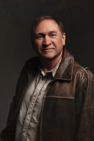 Image DC Scott in leather jacket looking at camera